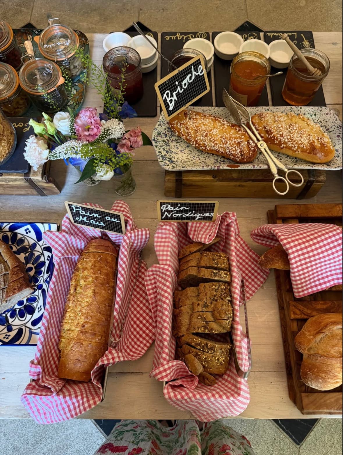 Brioche and fresh bread in checked napkins at breakfast
