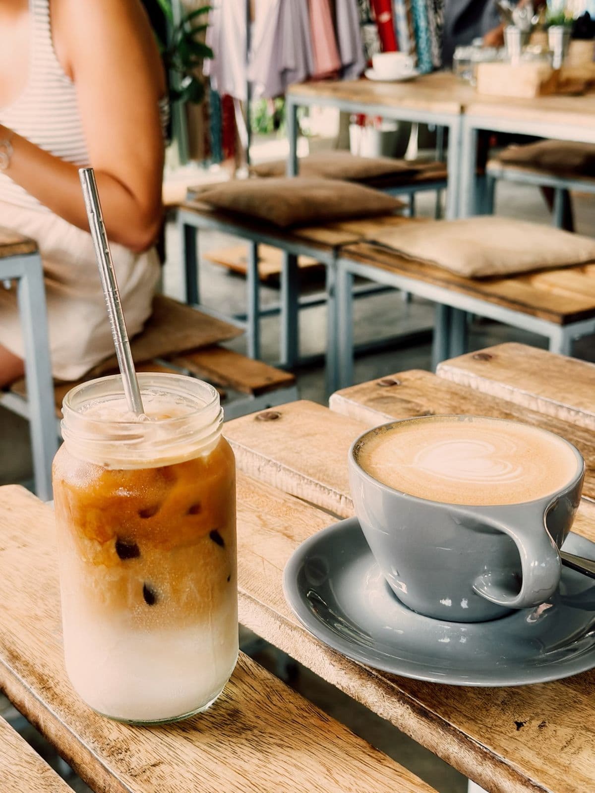 Iced latte next to a cappuccino