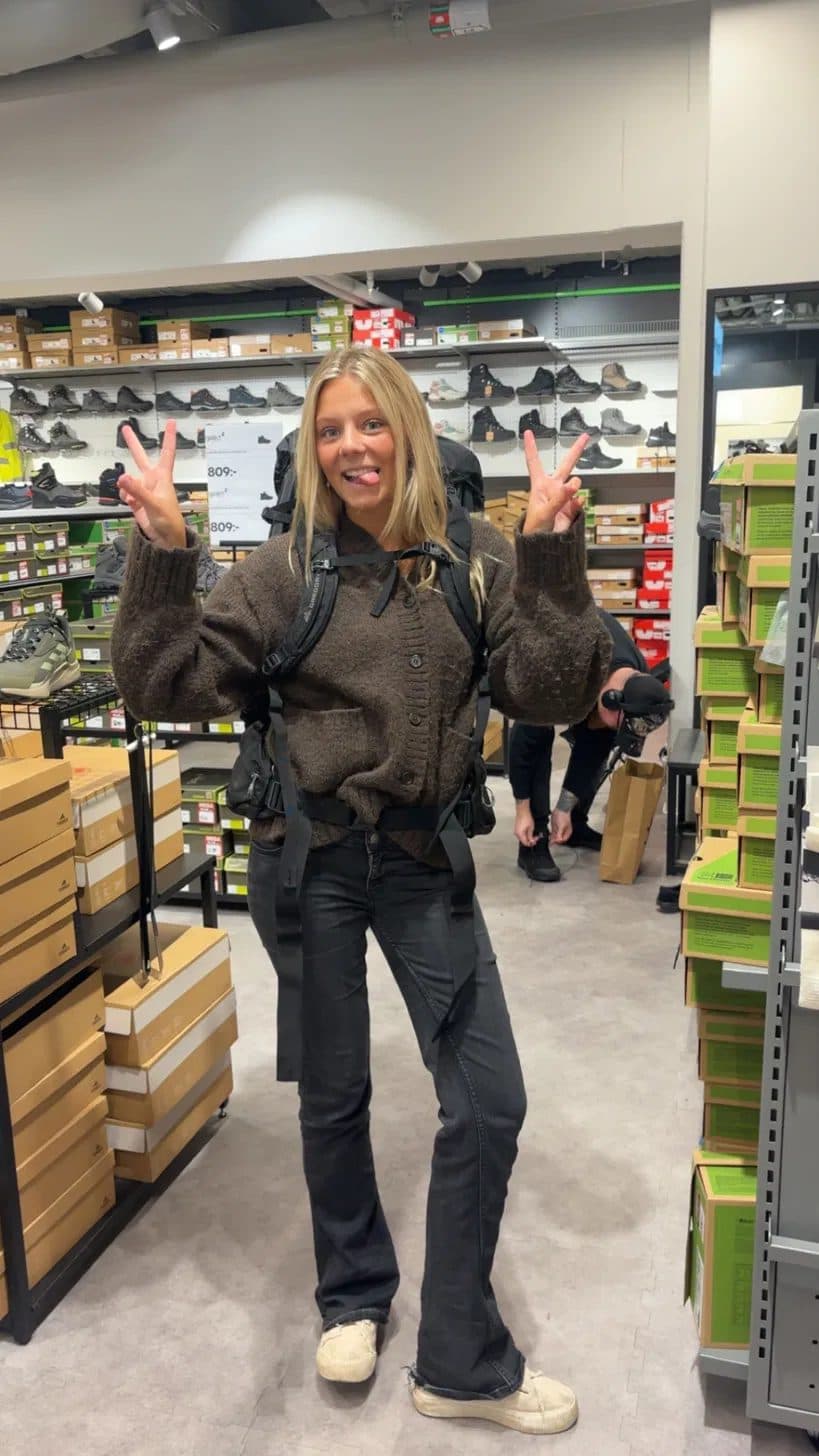 Emelie trying on a backpack before the trip