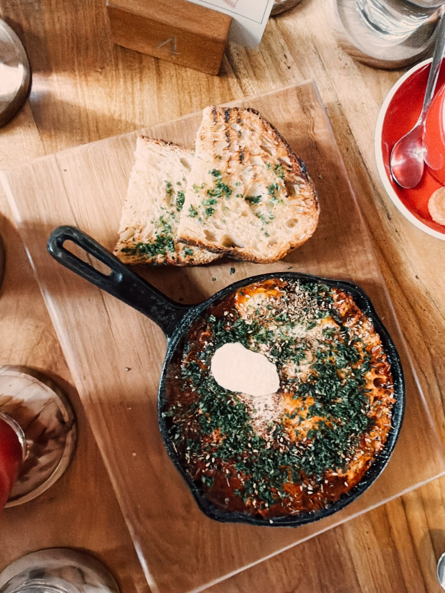 Shakshuka in a cast-iron pan with grilled sourdough