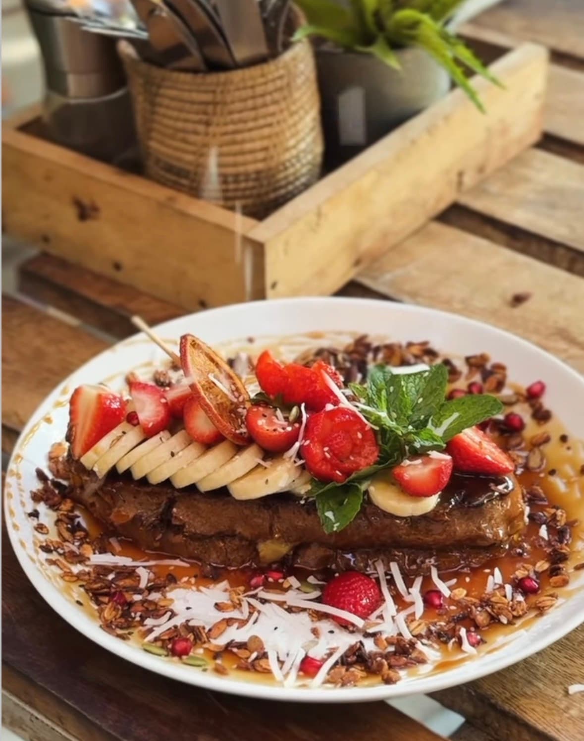 Banana and strawberry French toast with granola and coconut