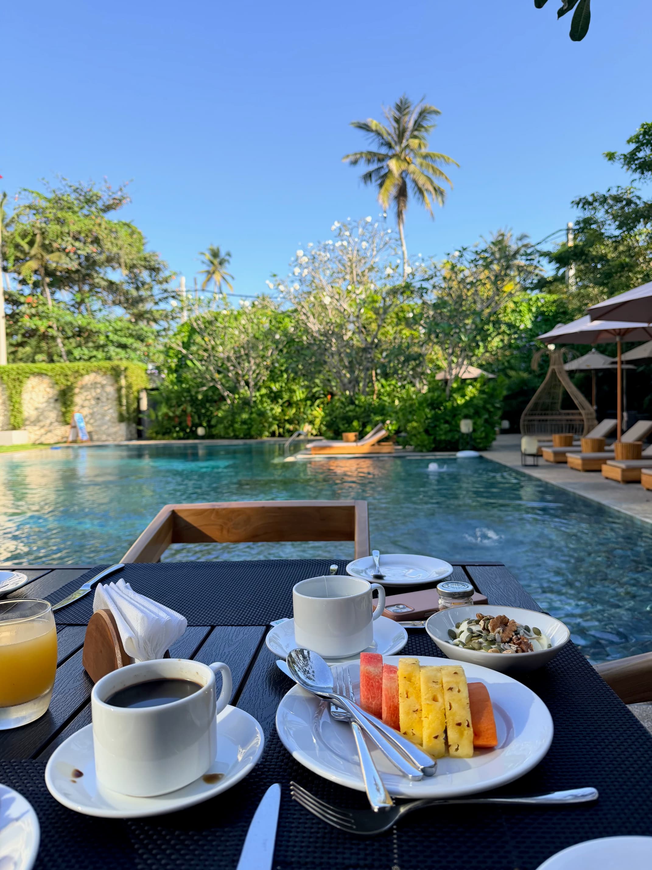 Breakfast with coffee and fresh fruit by the pool