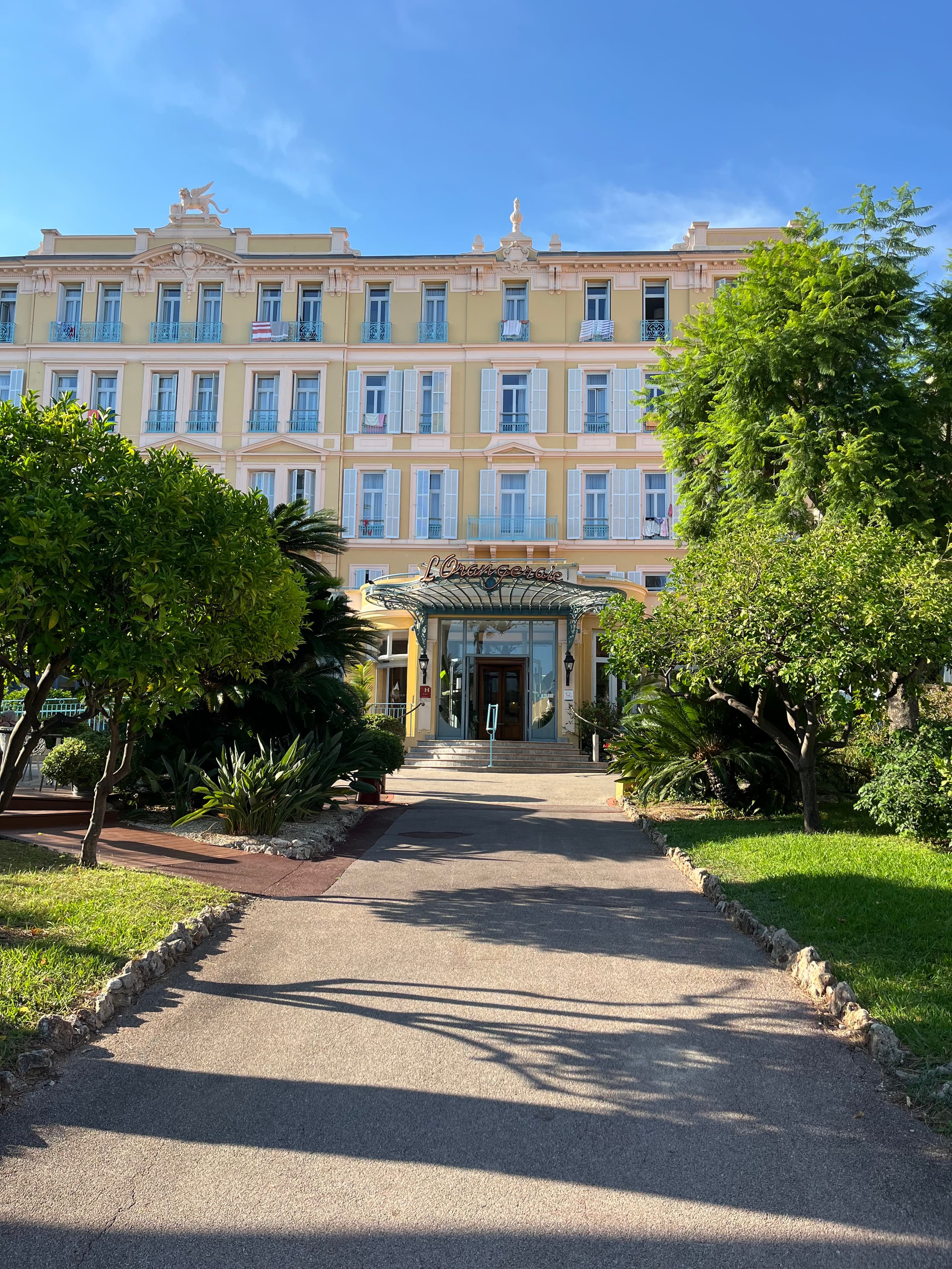 The yellow Belle Époque facade with blue balconies